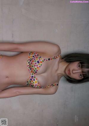 a japanese woman in a bikini is posing for the camera
