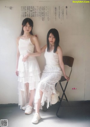 A couple of young women standing next to each other.