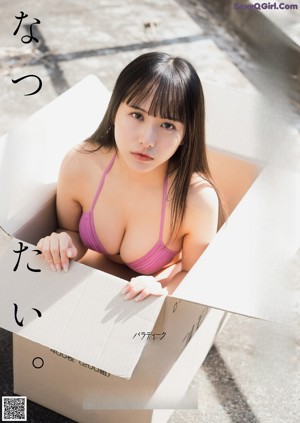 A woman in a pink bikini posing for a picture.
