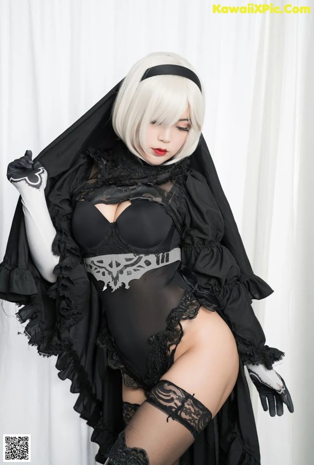 A woman in a black and white outfit posing for a picture.